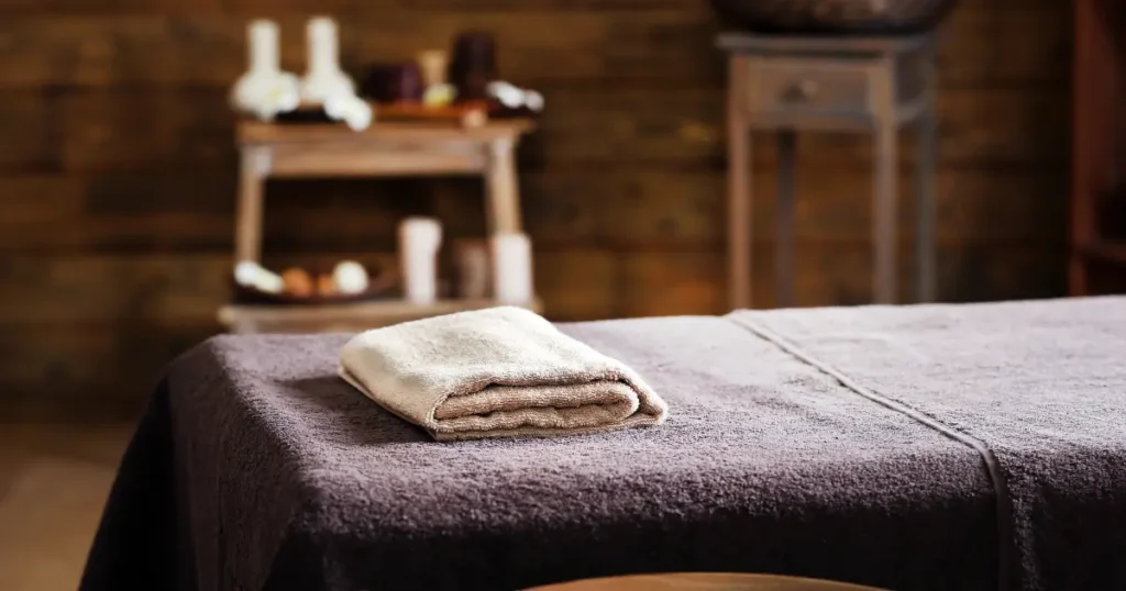 Massage bed covered with a towel in a spa room